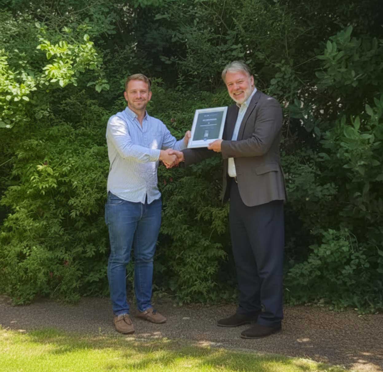 Head of Governance Matt Hayman receives the ESG certificate from ESH Head Ian Fairbairn