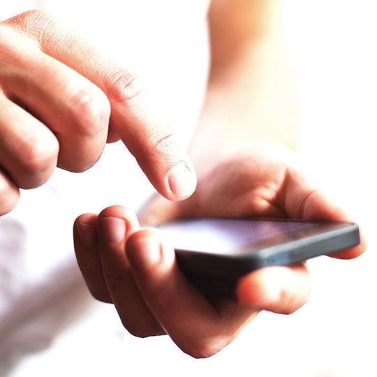 close up of hand holding a smartphone
