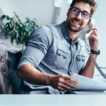 man using desk phone