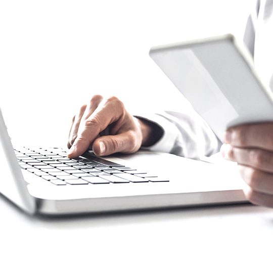 hands typing in a laptop