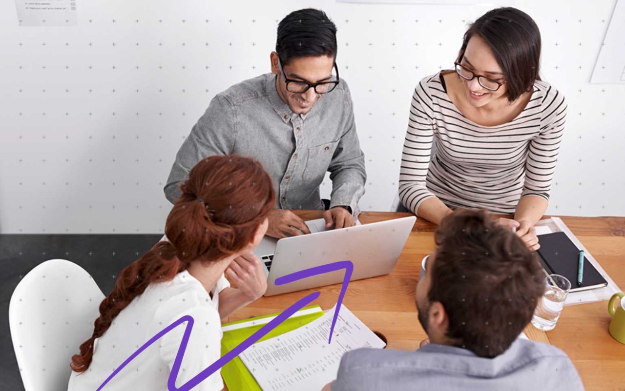 People holding a laptop and laughing