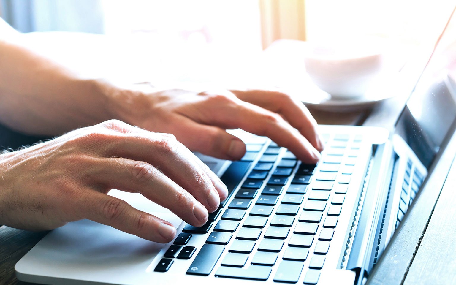 hands typing on a laptop