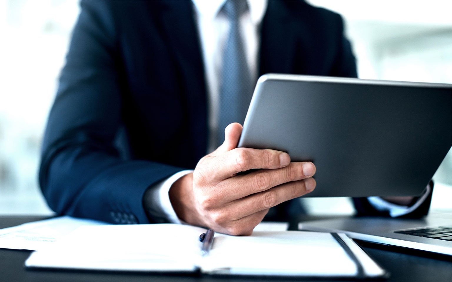 close up of businessman holding tablet