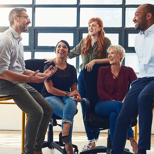 "Respect the Divine and Love People" group of colleagues in a meeting