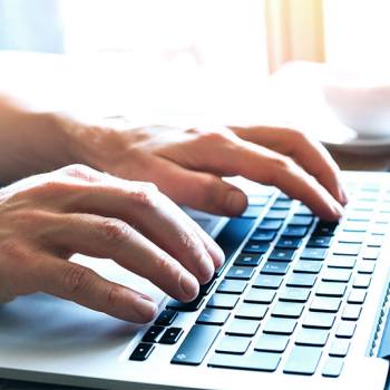 Kyocera Cloud Print and Scan: Privacy Statement hands typing in a laptop