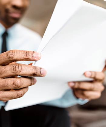 State of the art features man looking to papers