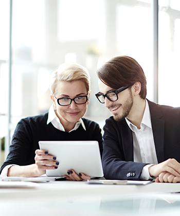 two colleagues looking at a tablet together
