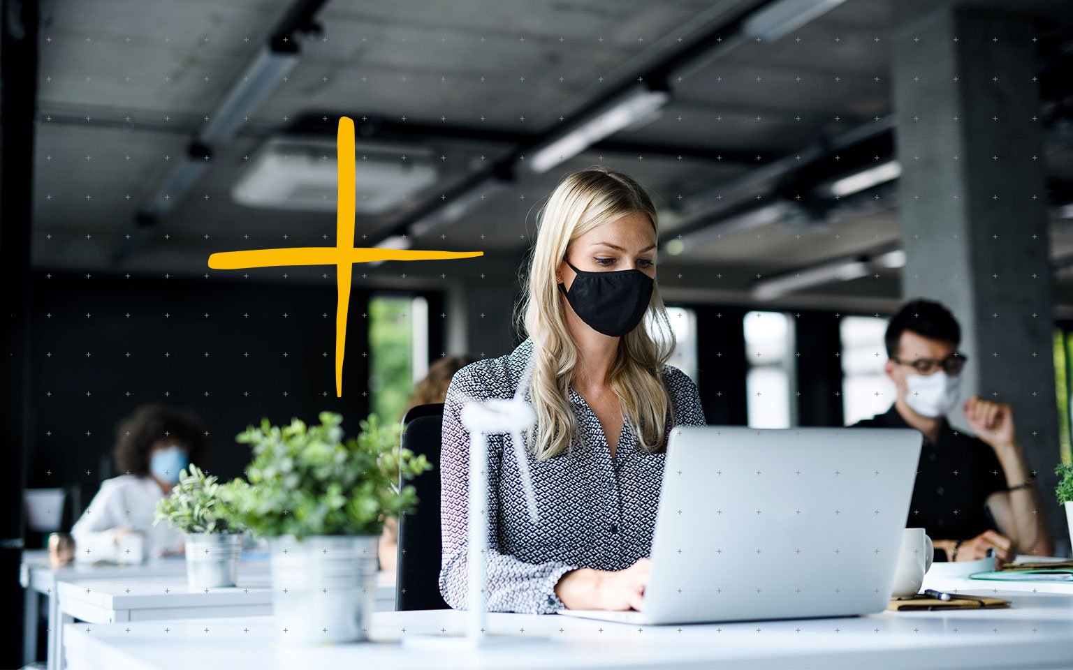 woman wearing mask working at computer